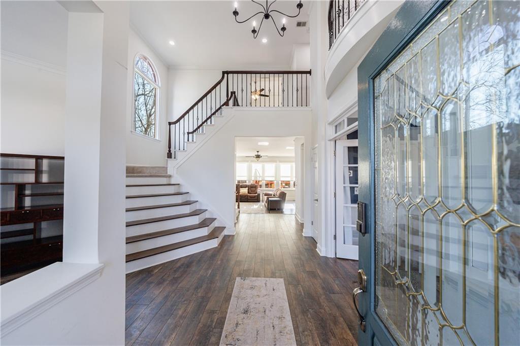 6010 Masters Club Drive Suwanee, GA 30024 - Photo 2 of 82 a view of a hallway with wooden floor and staircase