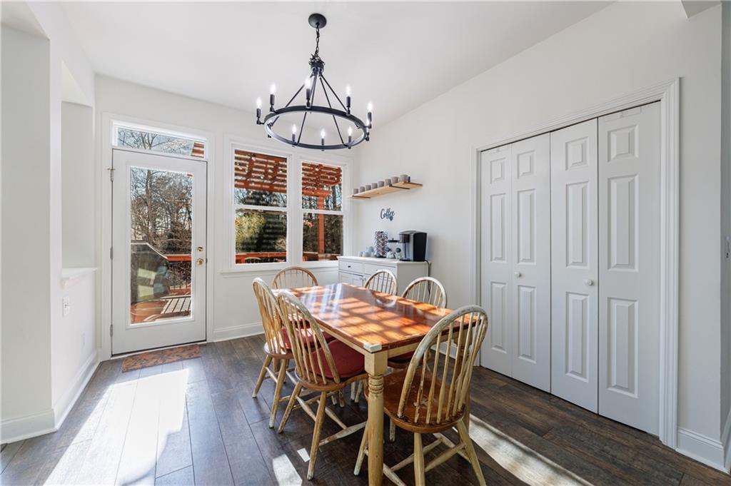 6010 Masters Club Drive Suwanee, GA 30024 - Photo 23 of 82 a view of a dining room with furniture window and wooden floor