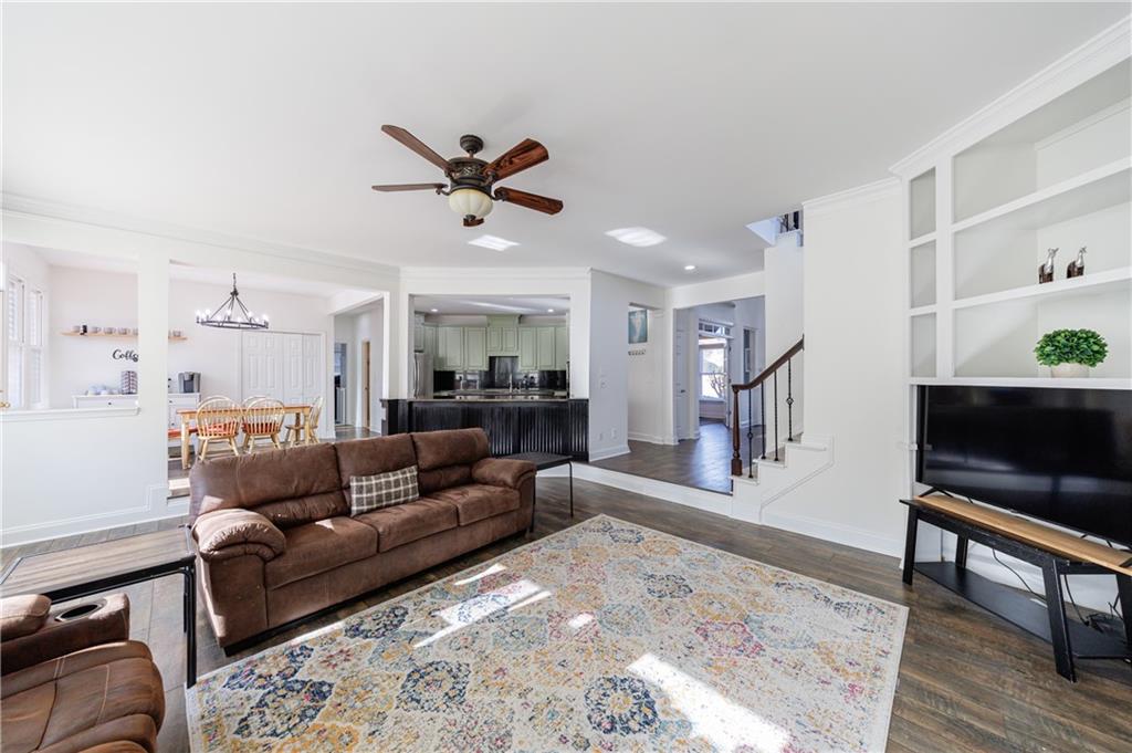 6010 Masters Club Drive Suwanee, GA 30024 - Photo 24 of 82 a living room with furniture and a wooden floor