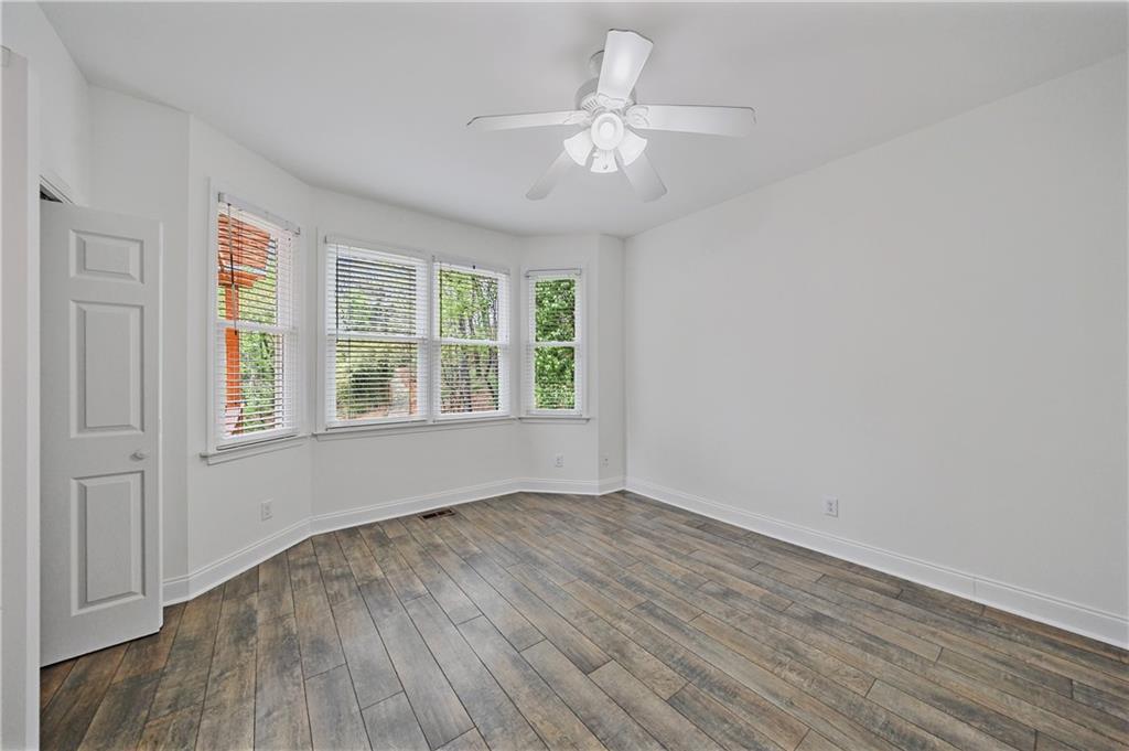 6010 Masters Club Drive Suwanee, GA 30024 - Photo 28 of 82 wooden floor in an empty room with a window