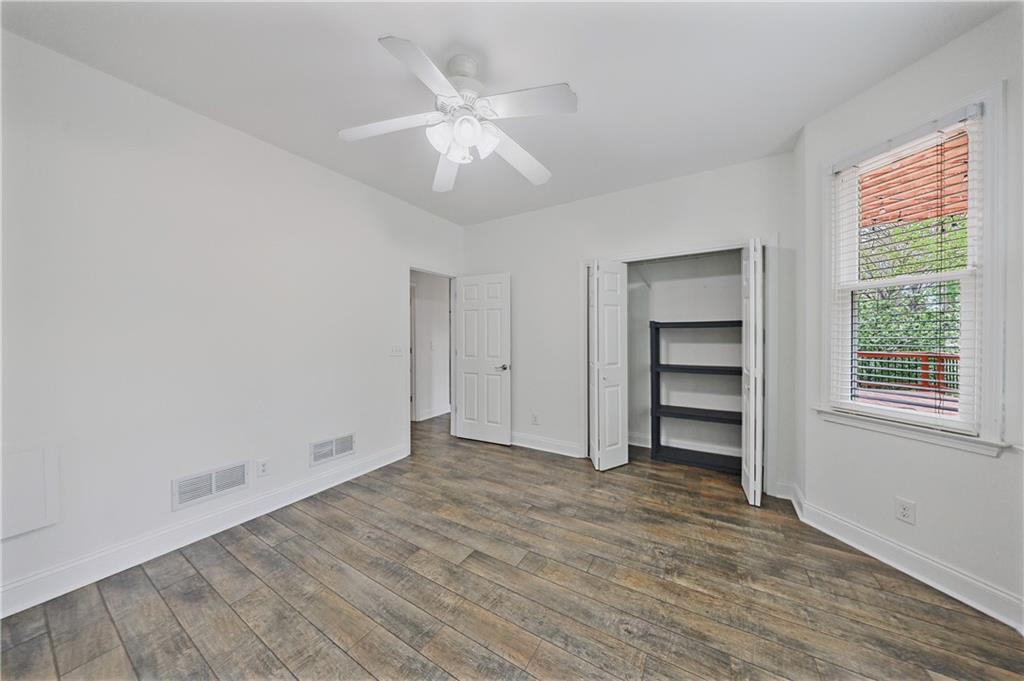 6010 Masters Club Drive Suwanee, GA 30024 - Photo 30 of 82 a view of empty room with wooden floor and fan
