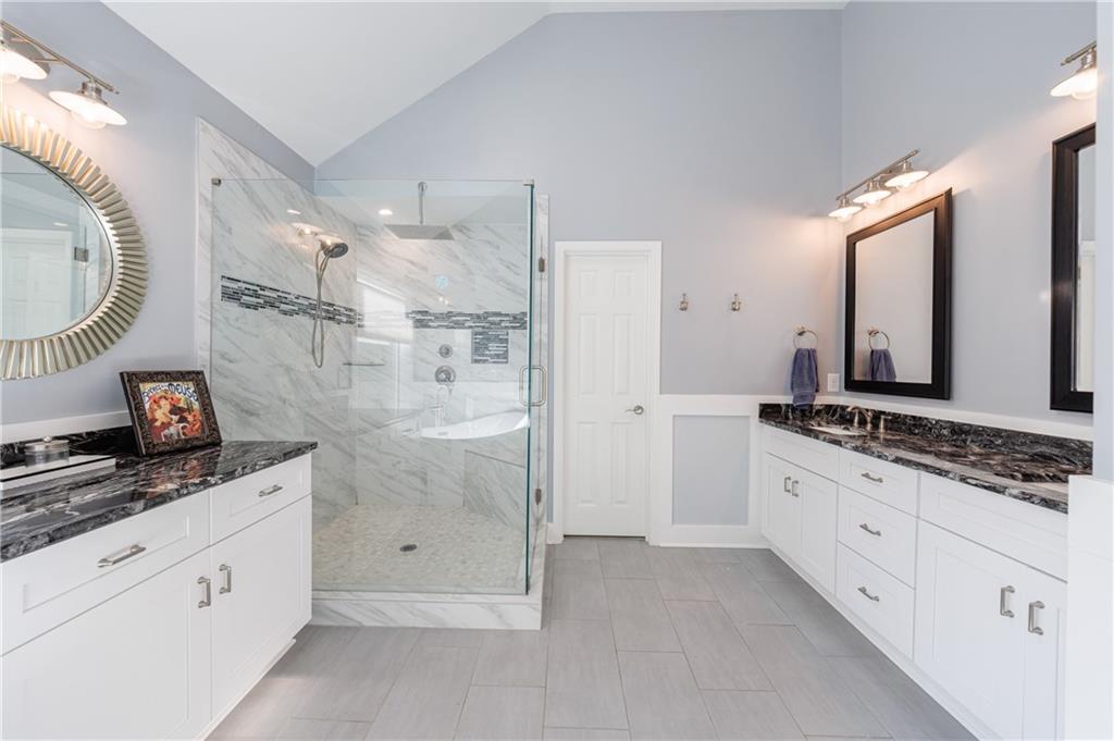 6010 Masters Club Drive Suwanee, GA 30024 - Photo 39 of 82 a spacious bathroom with a granite countertop double vanity sink mirror and