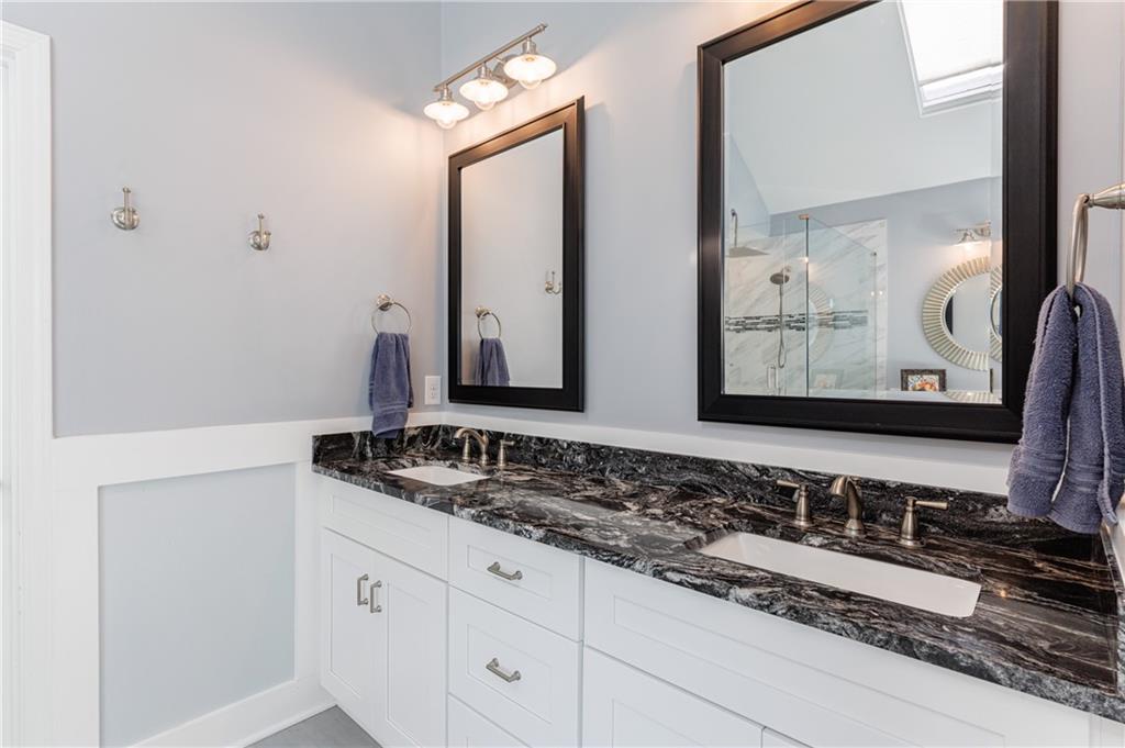 6010 Masters Club Drive Suwanee, GA 30024 - Photo 40 of 82 a bathroom with a sink and a mirror