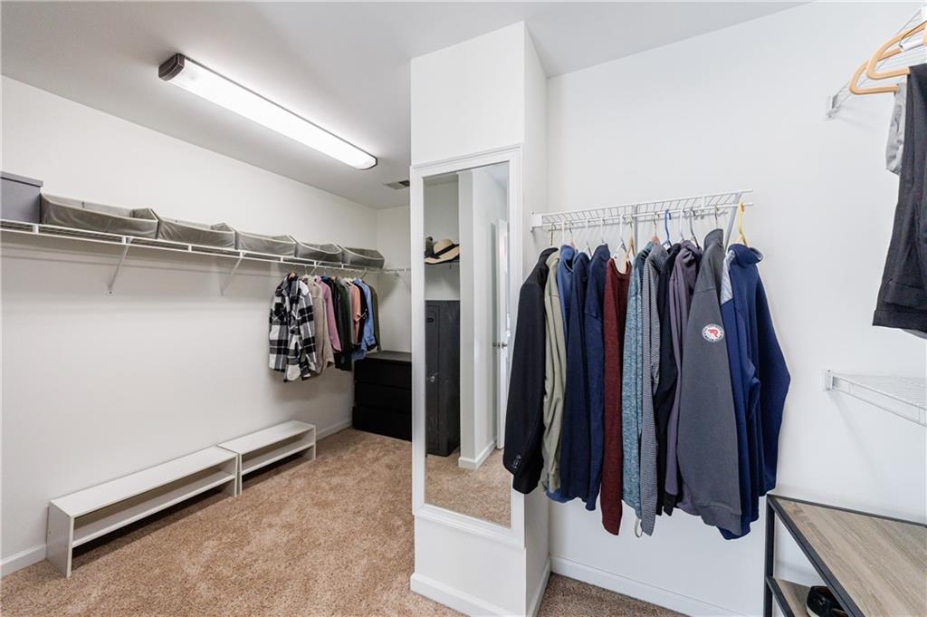 6010 Masters Club Drive Suwanee, GA 30024 - Photo 42 of 82 a view of walk in closet with clothes and shoes