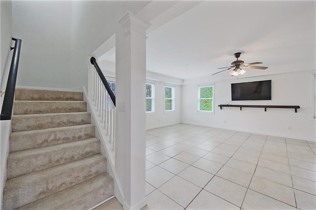 6010 Masters Club Drive Suwanee, GA 30024 - Photo 50 of 82 a view of an empty room with a fireplace and a chandelier