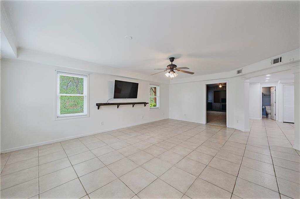6010 Masters Club Drive Suwanee, GA 30024 - Photo 54 of 82 a view of an empty room with a window and a kitchen
