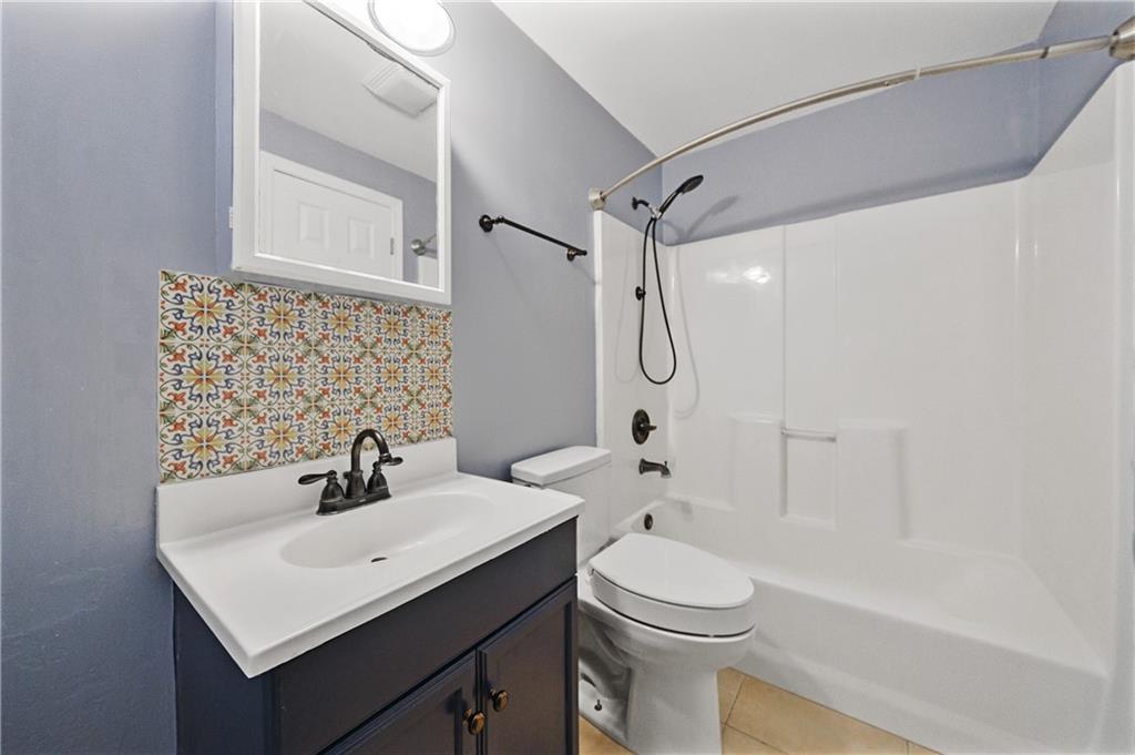 6010 Masters Club Drive Suwanee, GA 30024 - Photo 60 of 82 a bathroom with a sink a toilet and shower