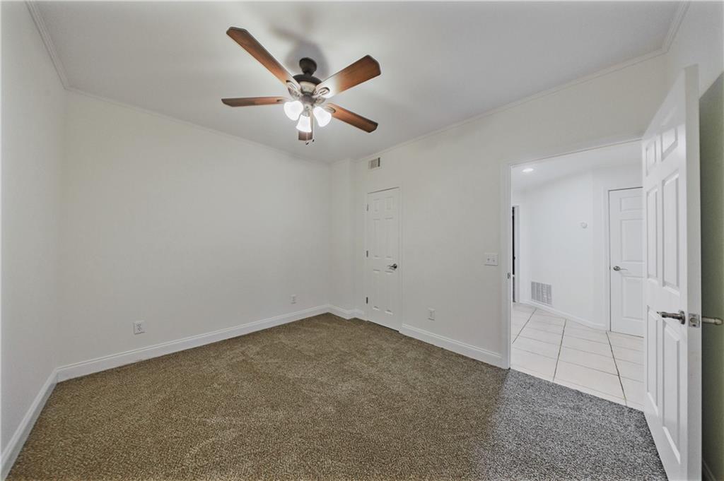 6010 Masters Club Drive Suwanee, GA 30024 - Photo 69 of 82 an empty room with closet and a chandelier fan