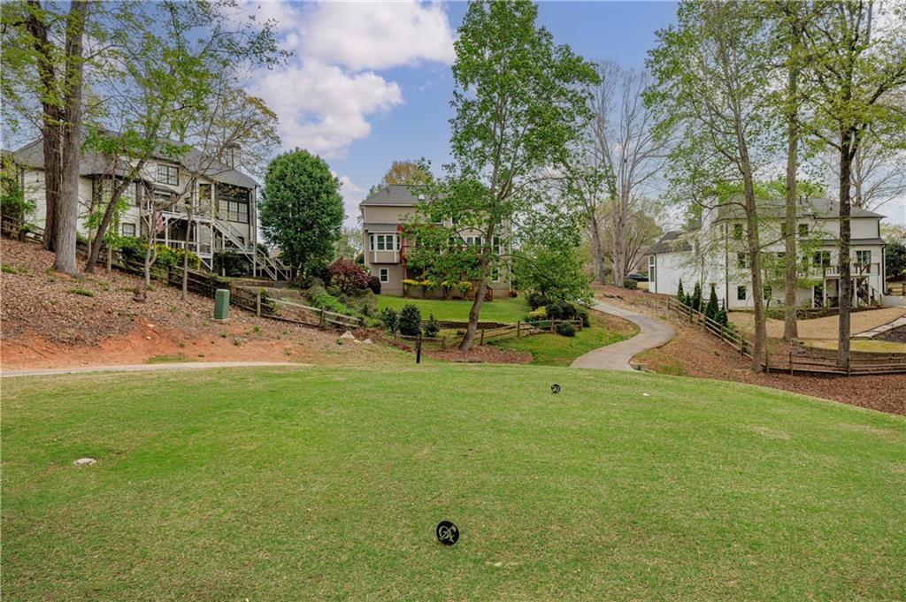 6010 Masters Club Drive Suwanee, GA 30024 - Photo 77 of 82 a view of a patio with table and chairs with wooden fence