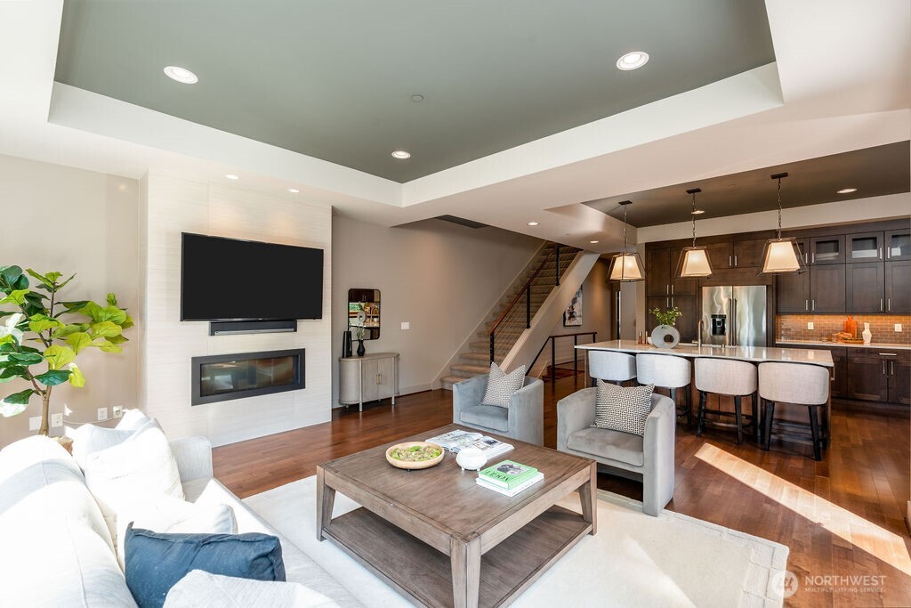 205 4th Court South, Unit 13 Kirkland, WA 98033 - Photo 1 of 33 a living room with furniture and a flat screen tv