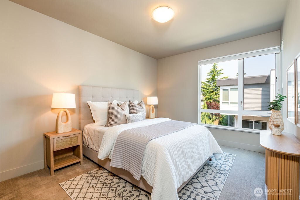 205 4th Court South, Unit 13 Kirkland, WA 98033 - Photo 17 of 33 a bedroom with a bed and a couch