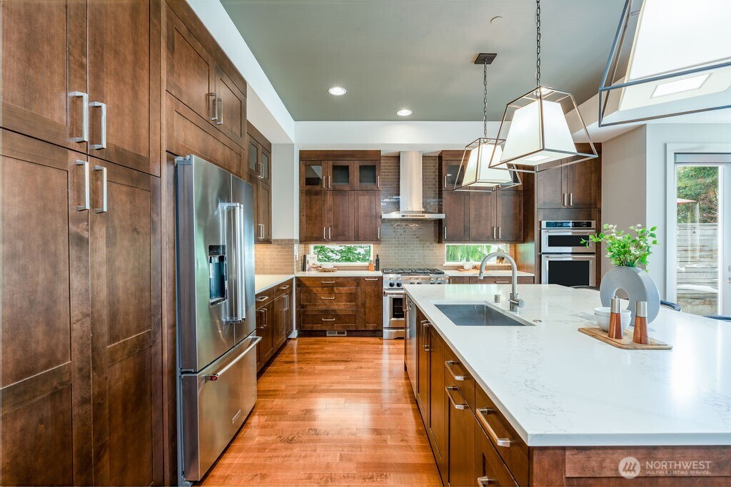 205 4th Court South, Unit 13 Kirkland, WA 98033 - Photo 8 of 33 a kitchen with kitchen island granite countertop a sink appliances and cabinets