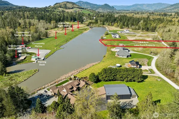 an aerial view of a house with a garden and lake view