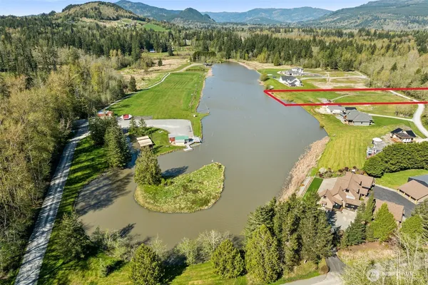 an aerial view of a house with a lake view