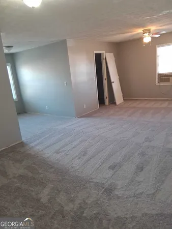 an empty room with window and stairs