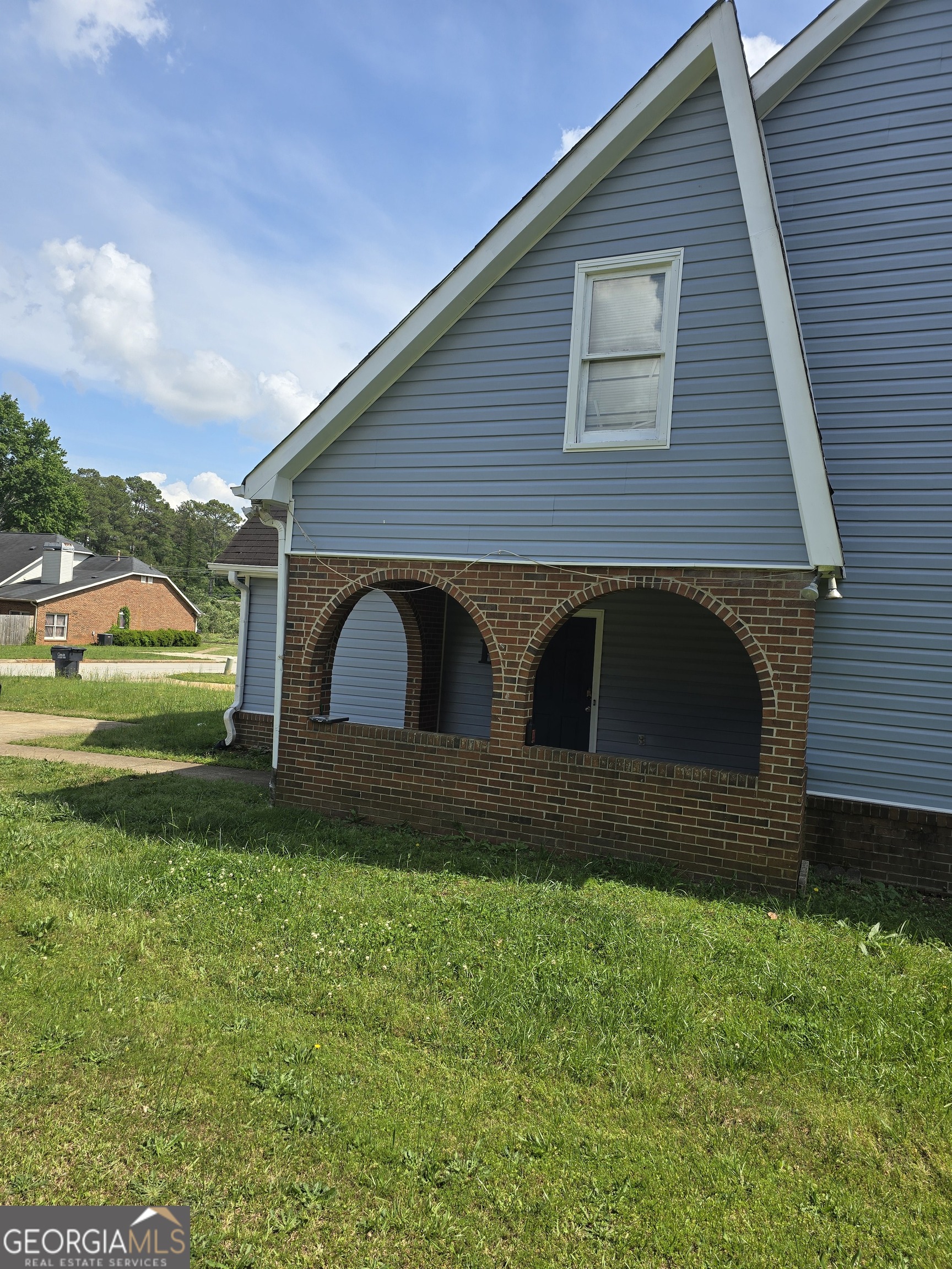 2798 Country Court Southeast, Unit B Conyers, GA 30013 - Photo 2 of 3 a front view of house with yard and green space