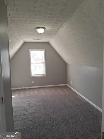 a view of an empty room and a window