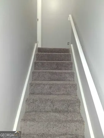a view of staircase with white walls