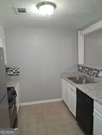 a kitchen with a sink and cabinets