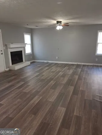 wooden floor in an empty room with a fireplace