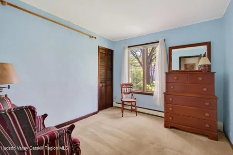 a room with a dresser and a window