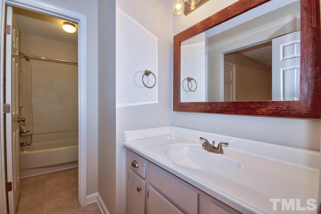 5512 Hamstead Crossing Raleigh, NC 27612 - Photo 13 of 16 a bathroom with a sink and a mirror