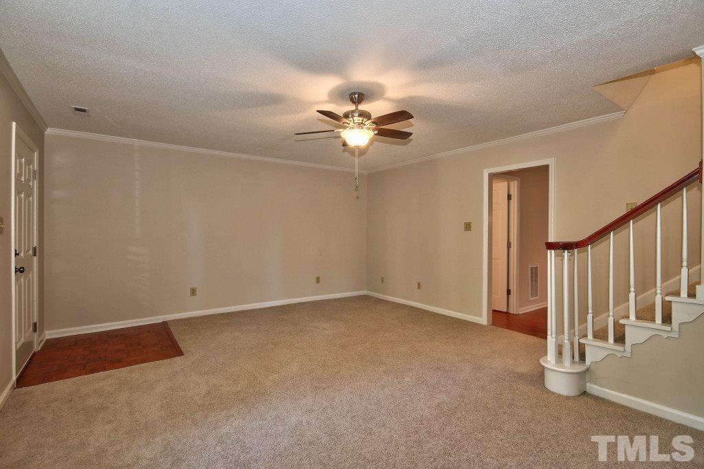 5512 Hamstead Crossing Raleigh, NC 27612 - Photo 4 of 16 a view of an empty room with a ceiling fan
