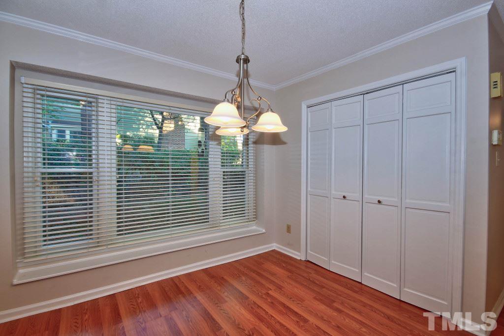 5512 Hamstead Crossing Raleigh, NC 27612 - Photo 7 of 16 a view of a room with wooden floor chandeliers and kitchen view