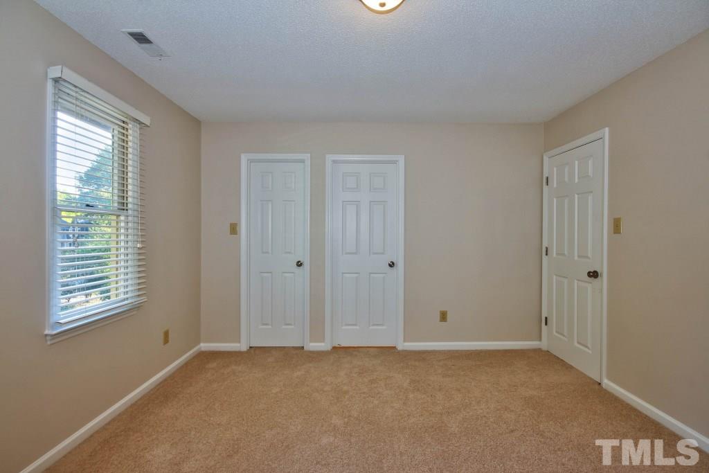 5512 Hamstead Crossing Raleigh, NC 27612 - Photo 9 of 16 a view of an empty room with a window