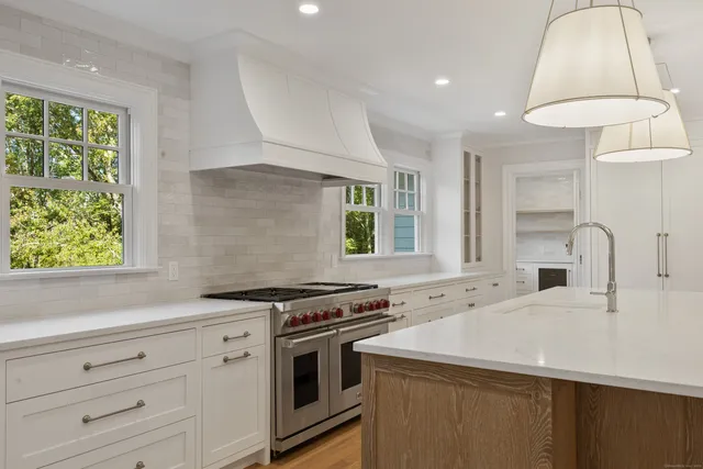 a kitchen with a stove cabinets and window