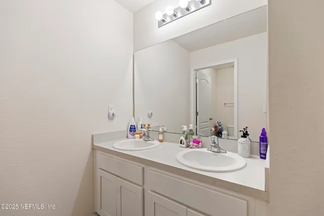a bathroom with a sink and a mirror