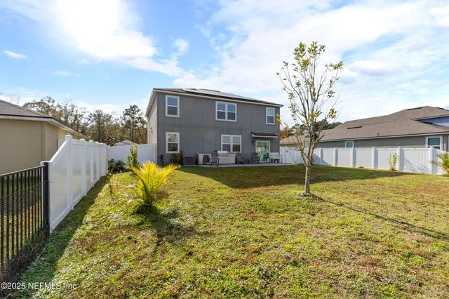 a house view with swimming pool in front of it