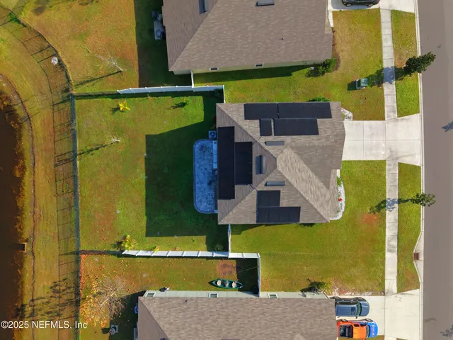 an aerial view of houses with swimming pool