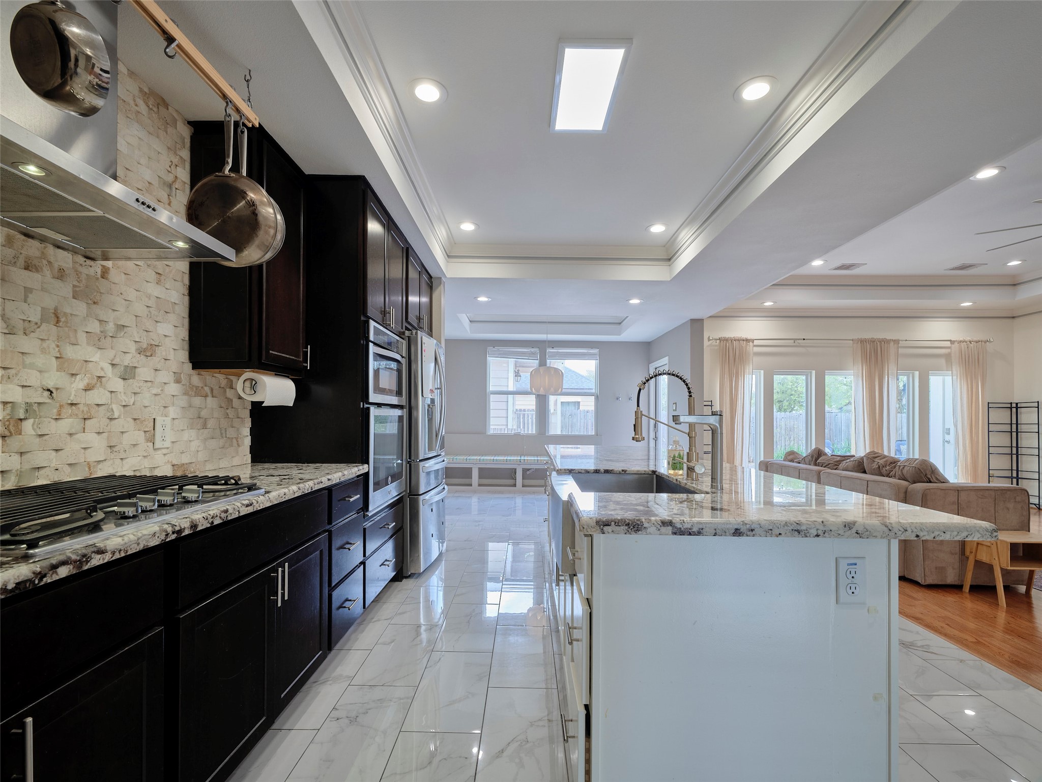4219 Redbud Street Houston, TX 77051 - Photo 10 of 25 This stunning open kitchen boasts sleek granite countertops and top-tier appliances, perfect for culinary enthusiasts and entertaining guests.