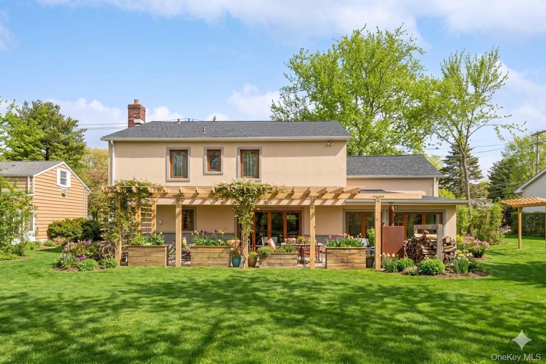719 Wilmot Road Scarsdale, NY 10583 - Photo 24 of 28 a view of a house with a yard