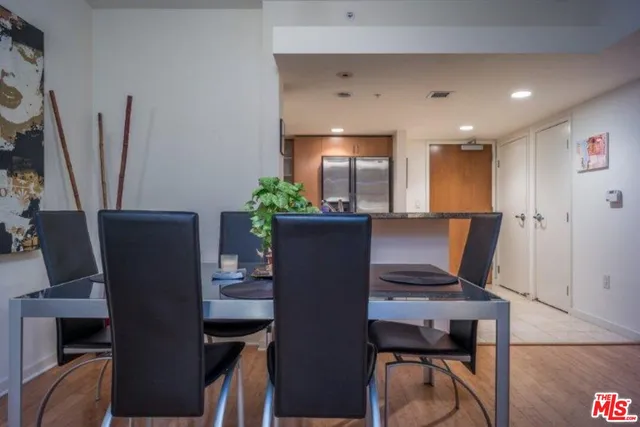 a view of a dining room with furniture and a potted plant