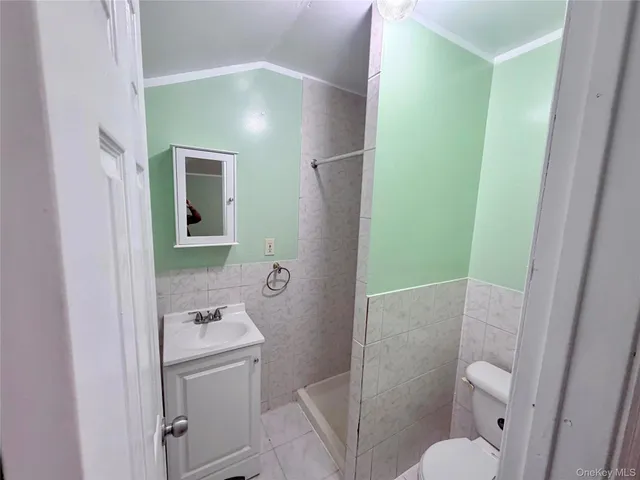 a bathroom with a sink and mirror with toilet