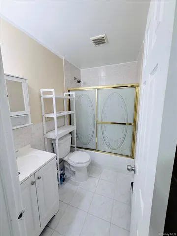 a bathroom with a toilet sink and shower