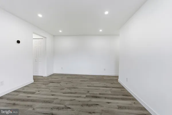 a view of room with wooden floor