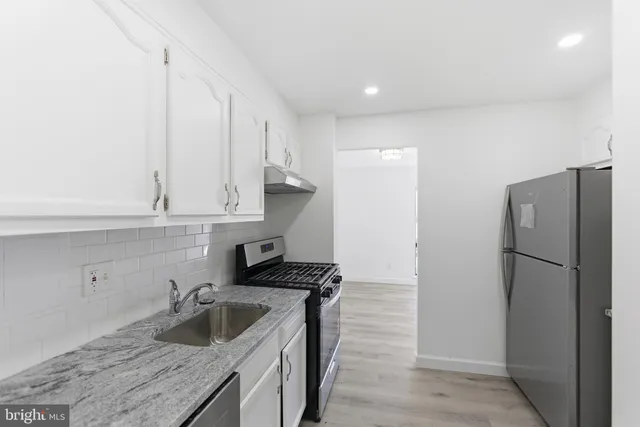 a kitchen with a refrigerator and a sink