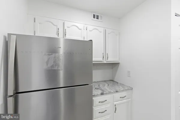 a view of a refrigerator in kitchen