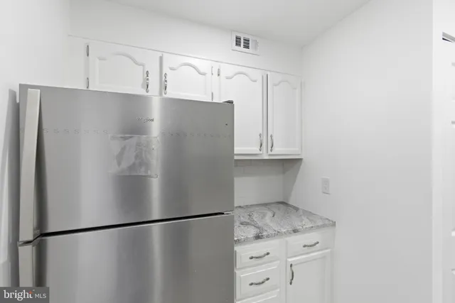 a view of a refrigerator in kitchen