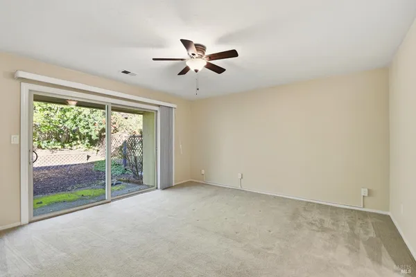 a view of room with window and ceiling fan