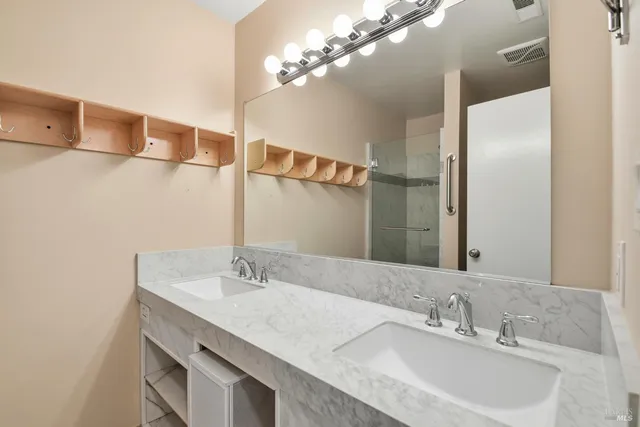 a bathroom with a sink double vanity and a mirror