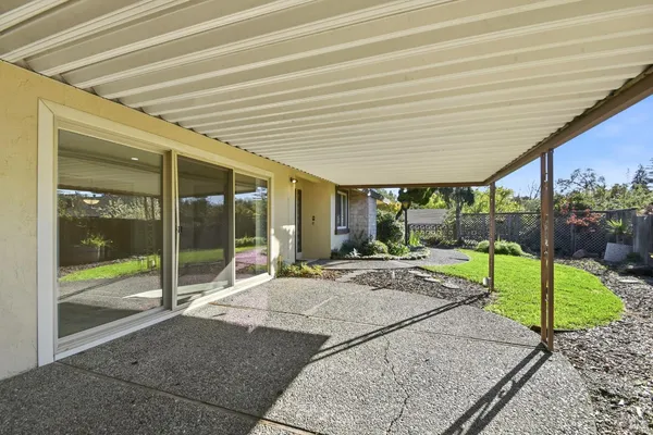 a view of a house with backyard and porch