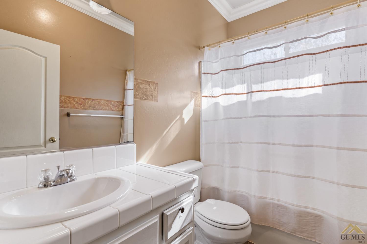 Undisclosed Address Bakersfield, CA 93306 - Photo 17 of 28 a bathroom with a sink toilet and shower