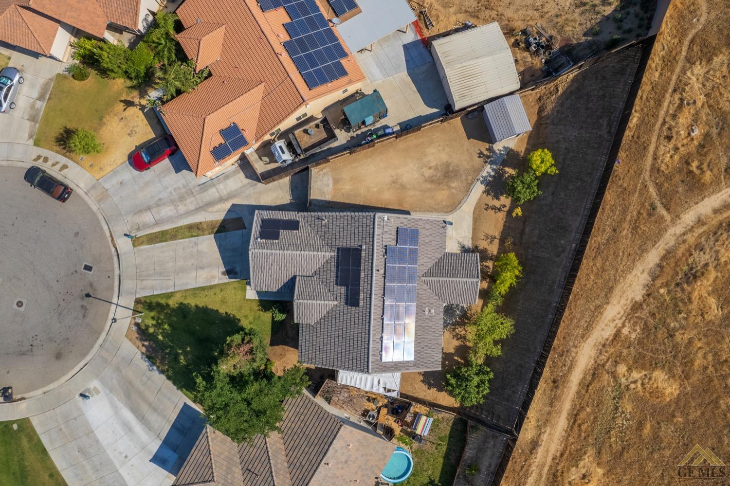 Undisclosed Address Bakersfield, CA 93306 - Photo 3 of 28 an aerial view of a house with a yard and potted plants