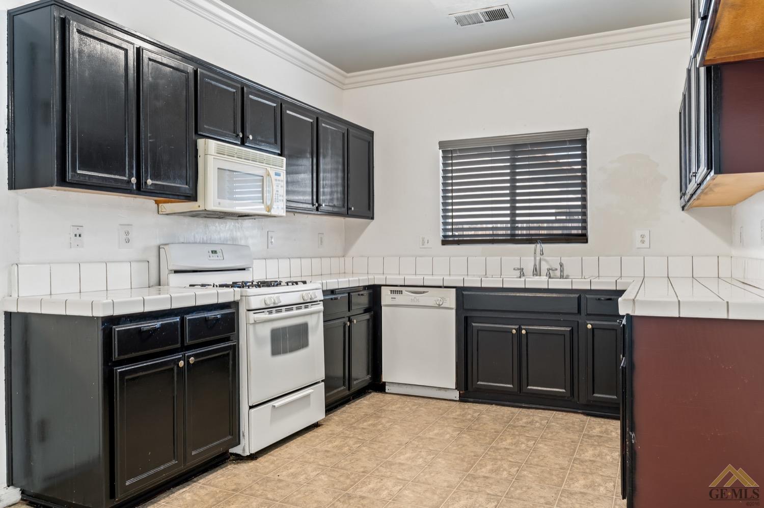 Undisclosed Address Bakersfield, CA 93306 - Photo 8 of 28 a kitchen with stainless steel appliances granite countertop a stove a sink and a microwave