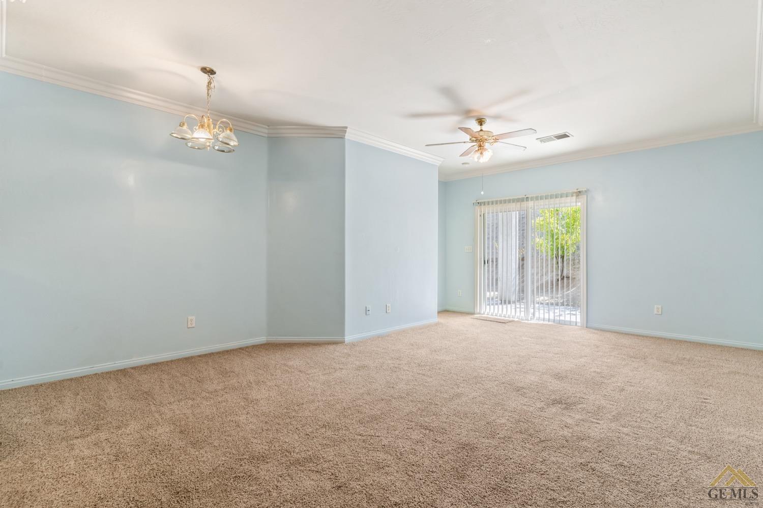 Undisclosed Address Bakersfield, CA 93306 - Photo 9 of 28 an empty room with windows and fan