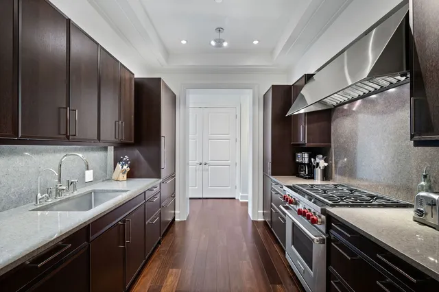 a kitchen with stainless steel appliances a stove a sink and a refrigerator